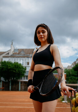 Young woman playing tennis on clay court