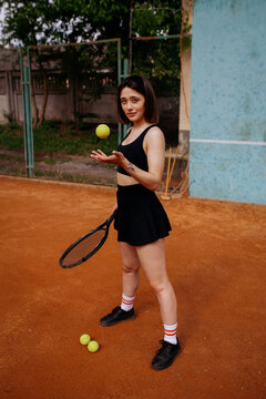 Young woman playing tennis on clay court