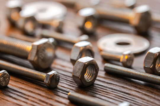 Metal nuts bolts washers fasteners on wood