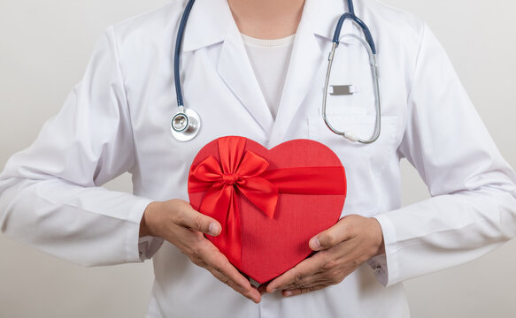 Doctor holds a symbolic human heart.
