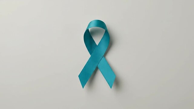 Teal awareness ribbon for ovarian and cervical cancer campaigns centered on a neutral surface