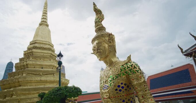 Wat Phra Kaew Temple that houses an ancient Emerald Buddha with golden angel Bangkok Thailand