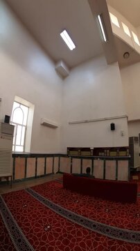 Serene prayer hall inside the historic Al-Ijabah Mosque in Medina, Saudi Arabia.