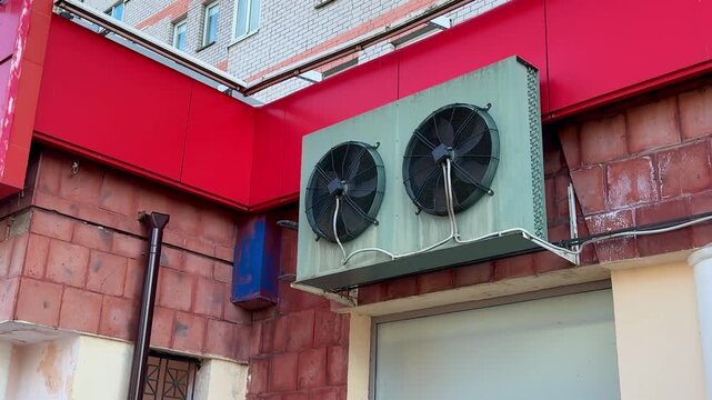 Close-up view of industrial cooling fans mounted at the top, ensuring optimal airflow in storage space. Installing industrial cooling fans above storage area enhances airflow and climate control