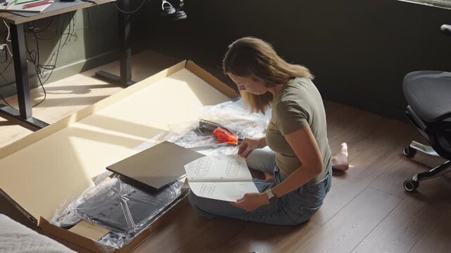 Woman reading instructions before assembling shelving unit