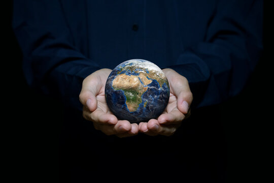 Business sustainability and environmental responsibility concept, hands holding planet Earth, representing sustainable business, ESG, and commitment to protecting the environment.