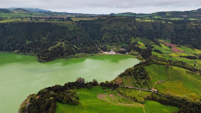 Aerial view of Lagoa das Furnas with green shoreline, farmland and forest on Sao Miguel island, Azores