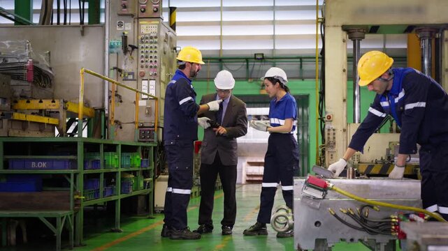 Industrial manufacturing team discussing production quality control in factory setting for engineering project and corporate business documentation