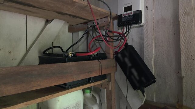 off-grid solar power setup with battery bank and inverter system in cabin