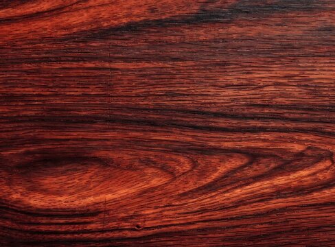 Dark red rosewood texture background with natural wood grain patterns and luxury surface.