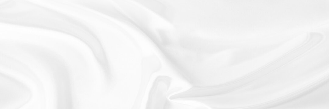 White gray satin texture that is white silver fabric silk panorama background with beautiful soft blur pattern natural.