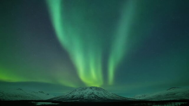 Vibrant Green Aurora Borealis Dancing Over Snow-Capped Mountain Under Starlit Night Sky