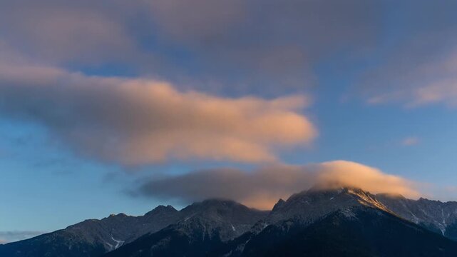 Dramatic Lenticular Cloud Crown Over Alpine Mountain Range at Sunset