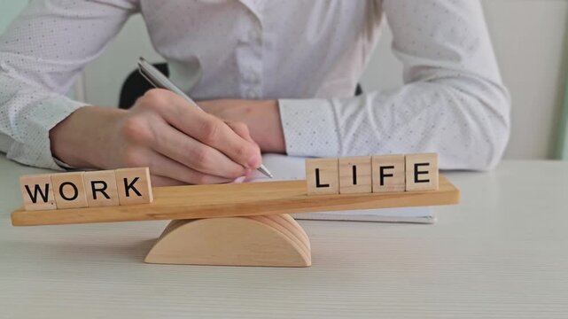Balancing work and life with wooden blocks on a desk