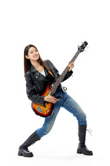 Fototapeta premium Energetic young woman playing bass guitar in rock pose on white