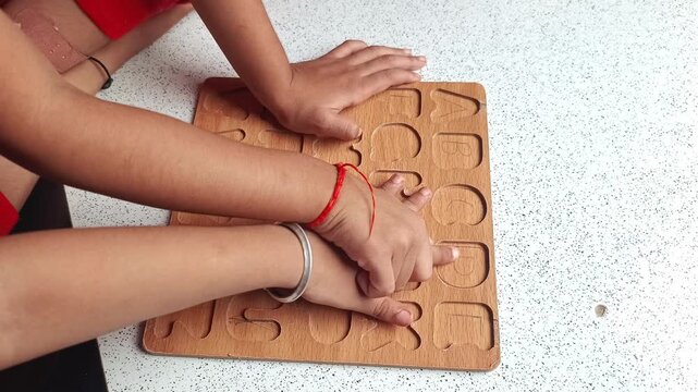 Children Learning English Alphabets Using Wooden Tracing Board at Home