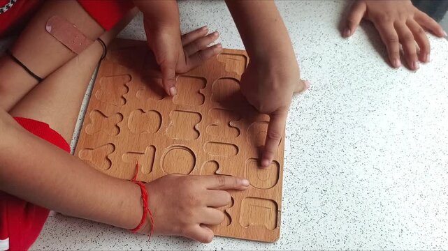 Children Learning English Alphabets Using Wooden Tracing Board at Home