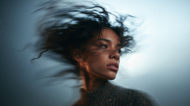 Young Woman with Windblown Hair in Motion Blur