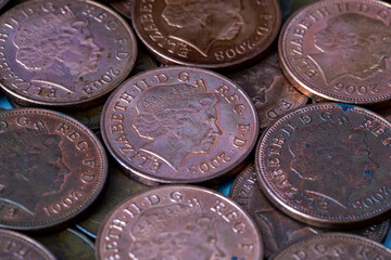 British pennies and two pence featuring Queen Elizabeth II profile portrait. British copper coins. Great Britain national currency. © Sergii