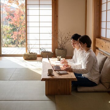Couple Using Laptop for Financial Planning in Traditional Japanese Room
