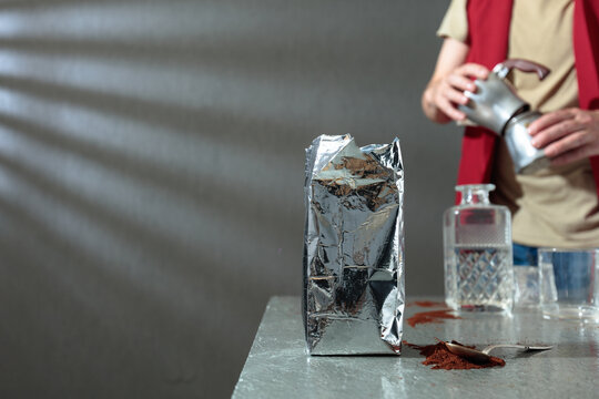 A barista prepares a coffee using a classic Italian moka pot.