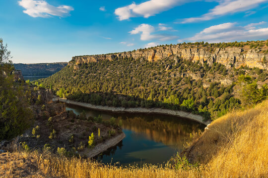 Hoces del Duraton canyon landscape view, Segovia Spain. Limestone cliffs and river bend under blue sky. High quality photo