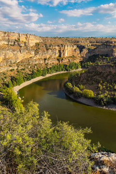 Hoces del Duraton canyon landscape view, Segovia Spain. Limestone cliffs and river bend under blue sky. High quality photo