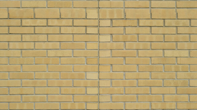 Yellow brick wall background. Textured masonry surface for architectural design projects.