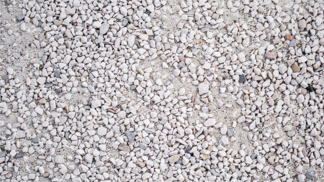 Top down view of white gravel texture. Small crushed stones background for construction design.