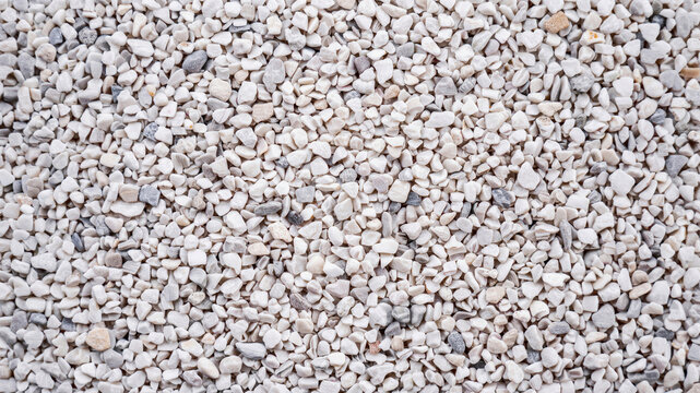 Top down view of grey gravel texture. Small crushed stones background for construction design.