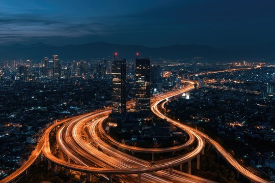 Illuminated highway interchange weaves through a sprawling city at twilight