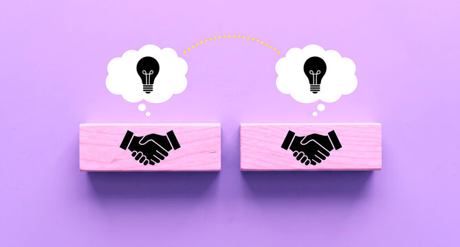 Two wooden blocks with handshake icons and lightbulb thought bub