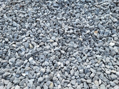 Crushed gray gravel and crushed stone aggregate background texture