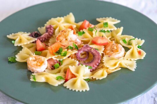 Farfalle pasta with shrimp, octopus and fresh tomato