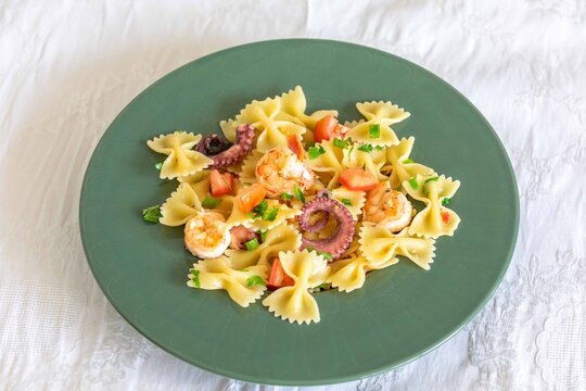 Farfalle pasta with shrimp, octopus and fresh tomato
