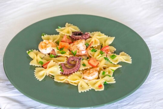 Farfalle pasta with shrimp, octopus and fresh tomato