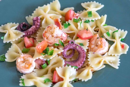 Farfalle pasta with shrimp, octopus and fresh tomato