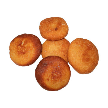Golden fried potato dumplings arranged in a circular pattern with soft lighting