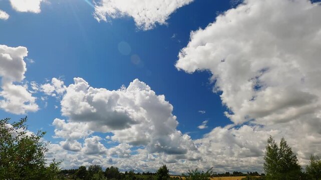 Bright Summer Cloudscape With Rapidly Moving Cumulus Clouds Over Low Horizon, Blue Sky Nature Timelapse