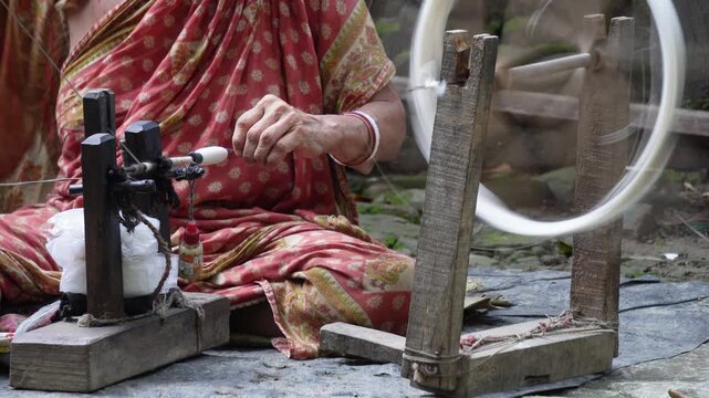Artisan spinning thread on a traditional charkha