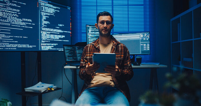 Confident Caucasian male engineer presents software strategy during late night work in office. Experienced tech consultant expertise, Innovative startup leader, Professional online conference concept.