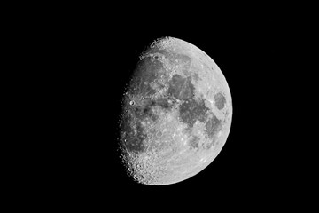 Waxing Gibbous Moon with Detailed Craters Against Black Sky © AdobeTim82