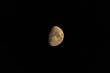 Waxing gibbous moon showing detailed lunar craters against black sky © AdobeTim82