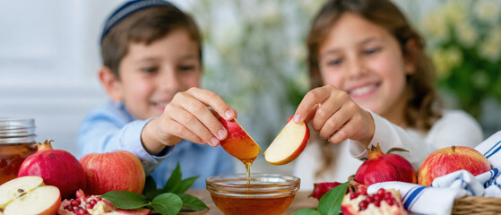 Naklejka premium Smiling children dipping apples together beside pomegranate, rosh hashanah family food ritual for a sweet jewish new year