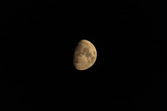 Waxing gibbous moon showing detailed lunar craters against black sky
