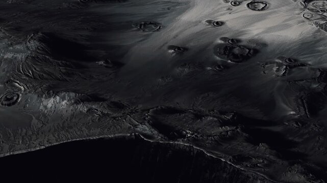 A view of a dark surface on a distant planet shows various round shapes and textures. The scene highlights the unique geological features of the area. This exploration took place in deep space.