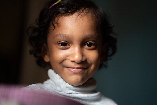 Close Up portrait of a toddler inside home looking at camera