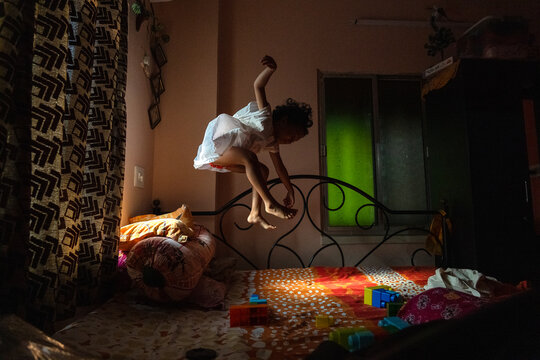 Little girl jumping and making fun 