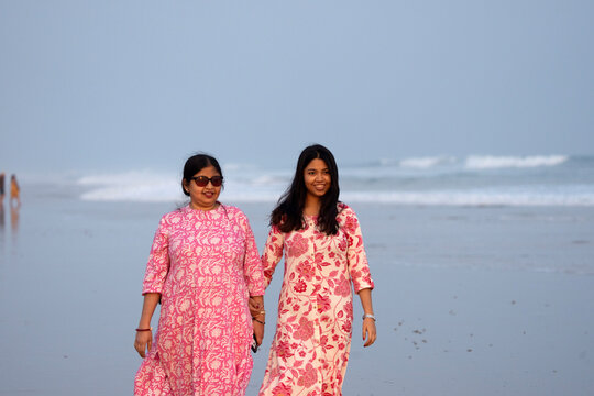 Mother and daughter enjoying holiday in sea beach