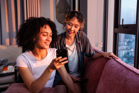 Two Women Sharing Content on Smartphone at Home